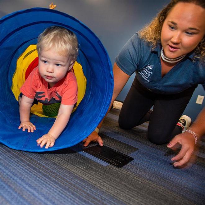 a student working with a kid at the occupational therapy pro bono clinic