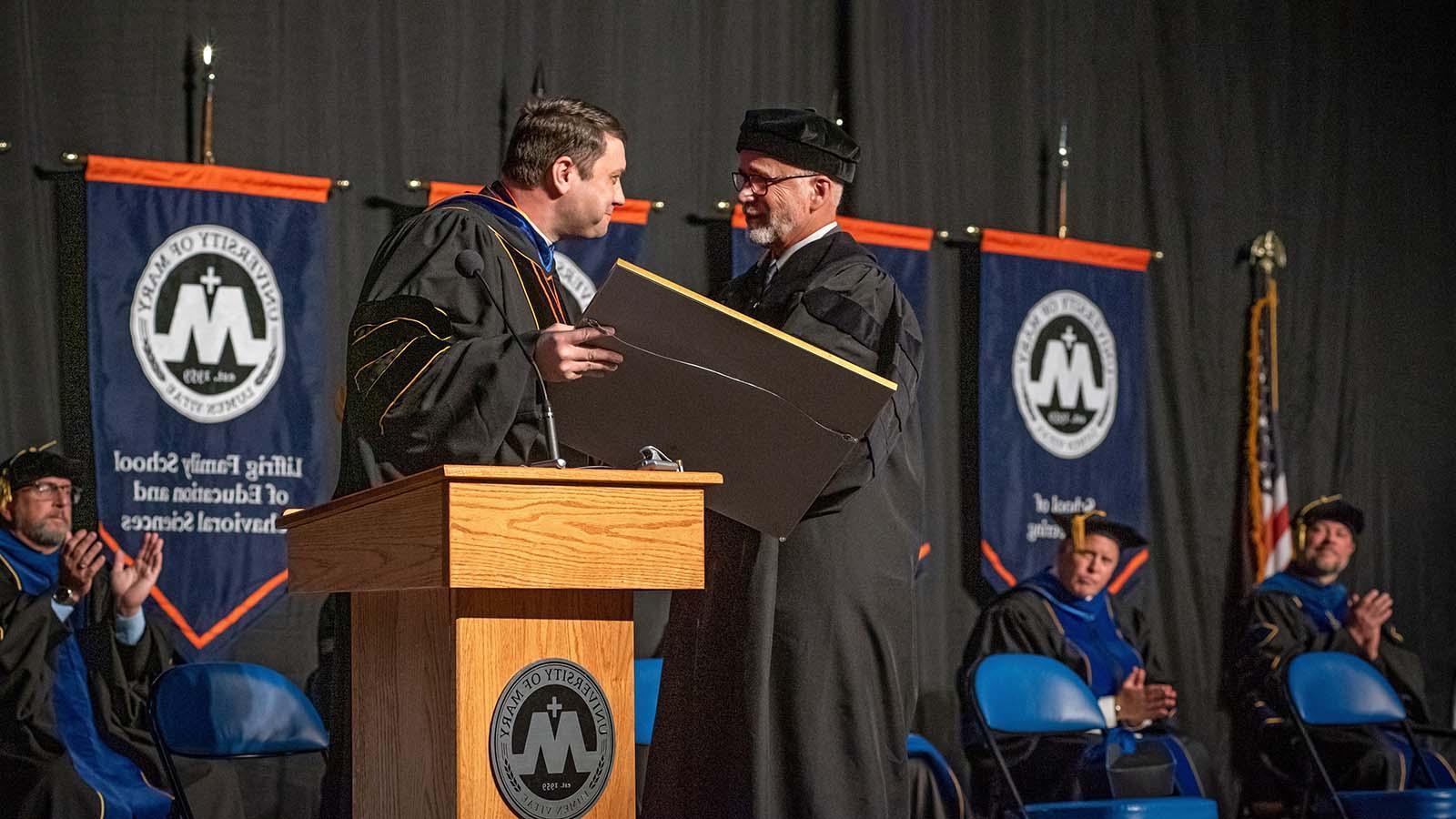 Monsignor giving an Honorary doctorate